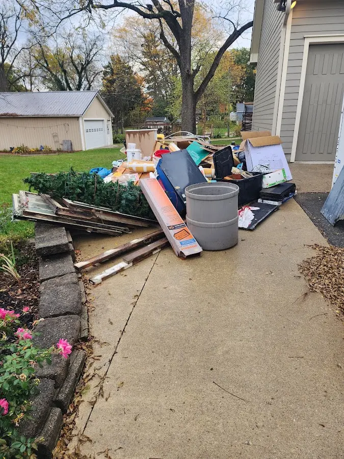 Dumpster being loaded with debris for Commercial Dumpster Rental in Rio Communities